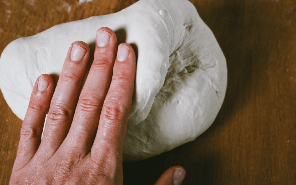 hand kneading folding the dough